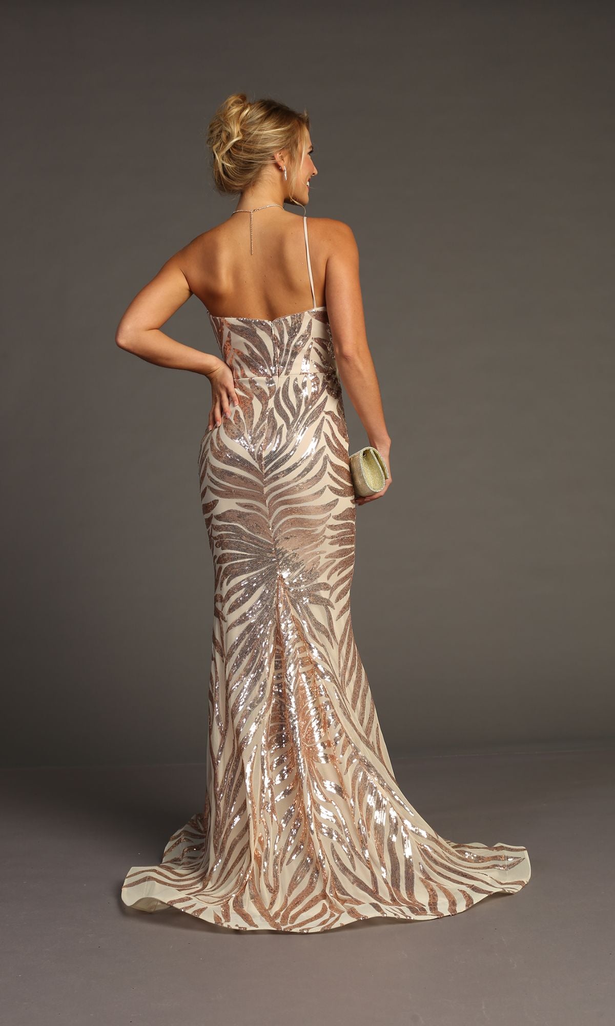 A woman models the Sequin-Print One-Shoulder Prom Dress: Chicas C823, featuring a floor-length zebra pattern and holding a small clutch against a gray background.